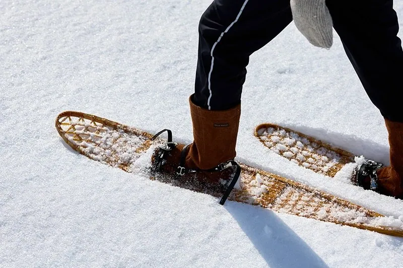 Person walking in snowshoes across deep snow